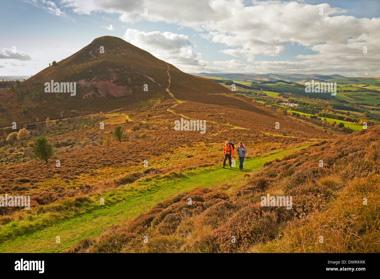 Walkers between Eildon Mid Hill and North Hill in the Eildon Hills near Melrose Stock Photo
