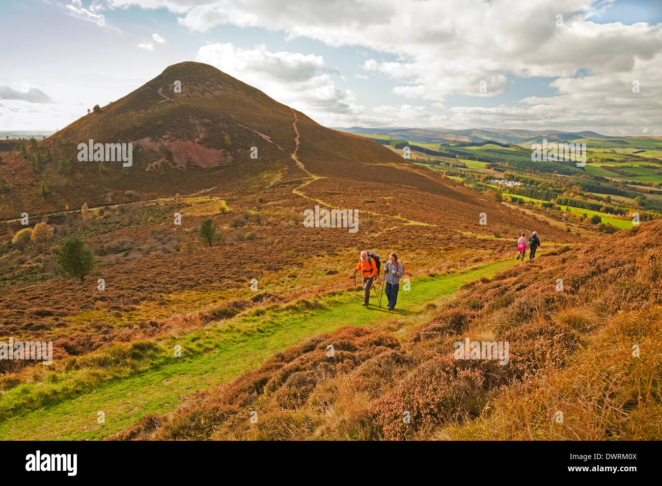 Walkers between Eildon Mid Hill and North Hill in the Eildon Hills near Melrose Stock Photo