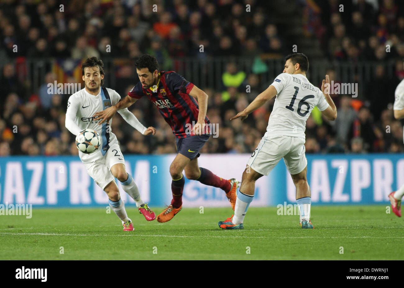 Barcelona, Spain. 12th Mar, 2014. Busquets challengeds by Silva and Aguero during the Champions league game between Barcelona and Manchester City from the Nou Camp Stadium. Credit:  Action Plus Sports/Alamy Live News Stock Photo