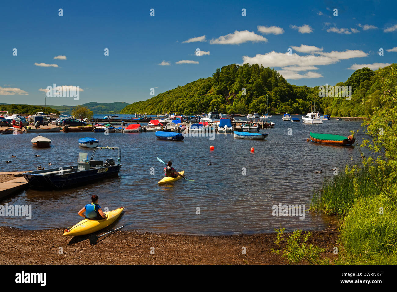 Kayaking at Balmaha Boatyard on Loch Lomond. Inchcailloch is in the background. Stock Photo