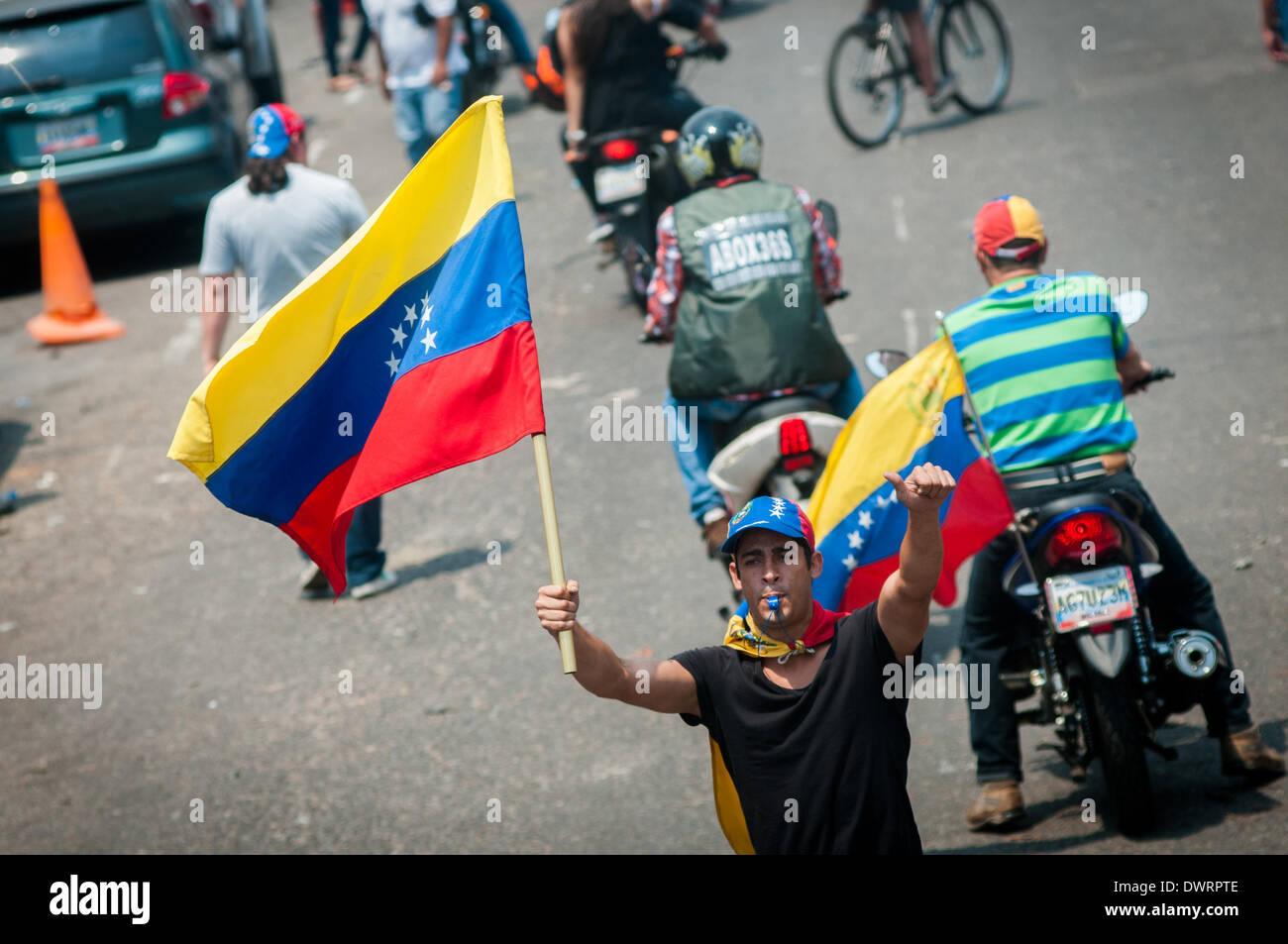 Tachira, Venezuela. 12th Mar, 2014. A demonstrator holds a Venezuelan national flag during a rally in front of the Public Ministry, in Tachira state, Venezuela, on March 12, 2014. Credit:  Manaure Quintero/Xinhua/Alamy Live News Stock Photo
