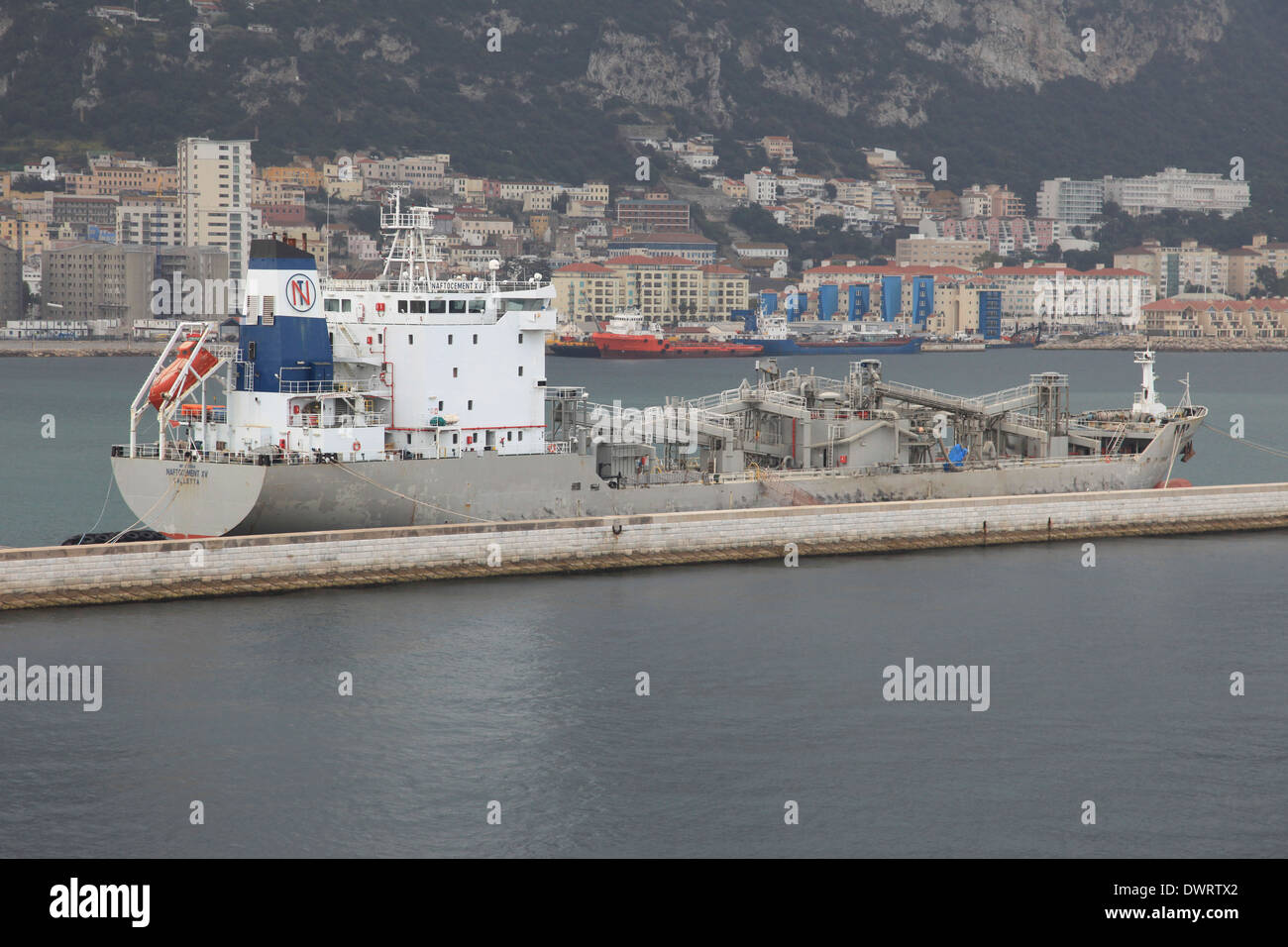 Cement carrier ship mv Naftocement XV alongside Gibraltar harbor Stock Photo