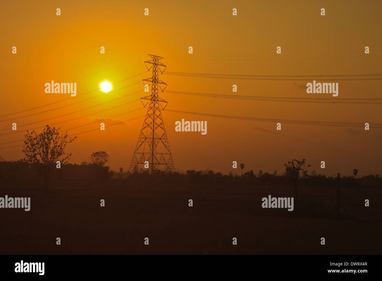 High voltage power pylons in sunset scene twilight Stock Photo - Alamy