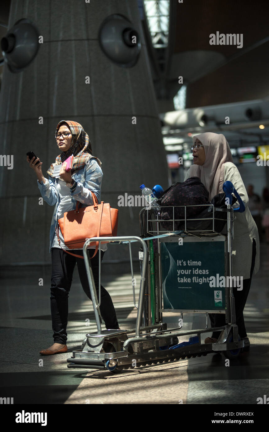 Sepang, Malaysia. 11 March 2014. Travellers make their way through the ...