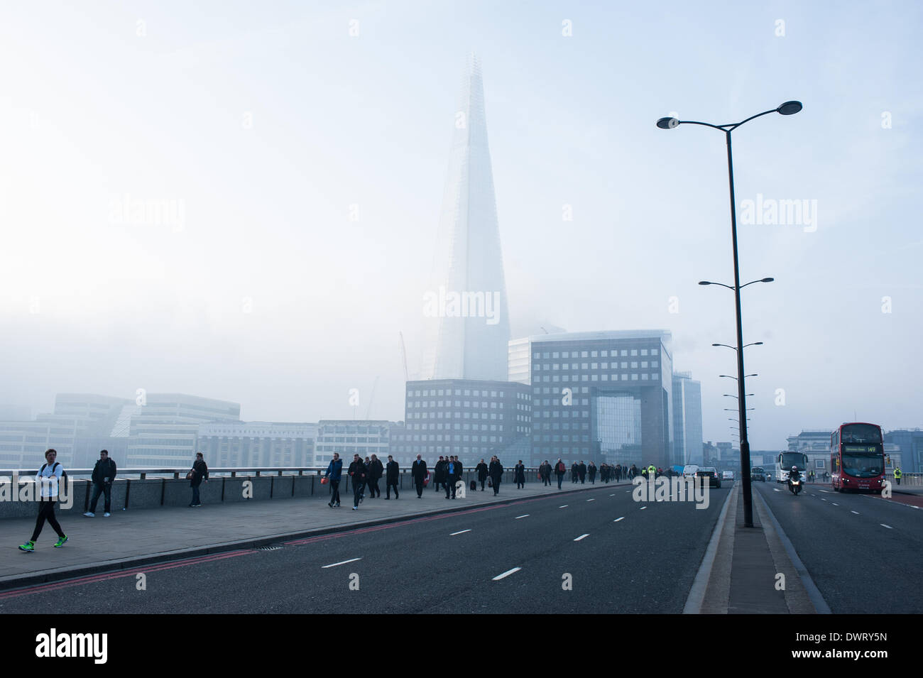 London, UK. 13th March 2014. morning commuters on London Bridge as London wakes up under heavy fog Credit:  Piero Cruciatti/Alamy Live News Stock Photo