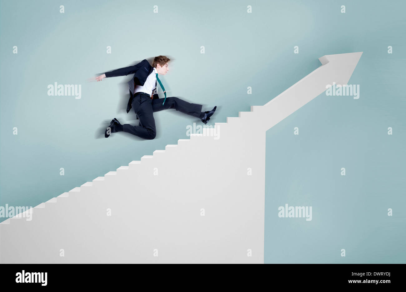 a businessman running towards stairs Stock Photo