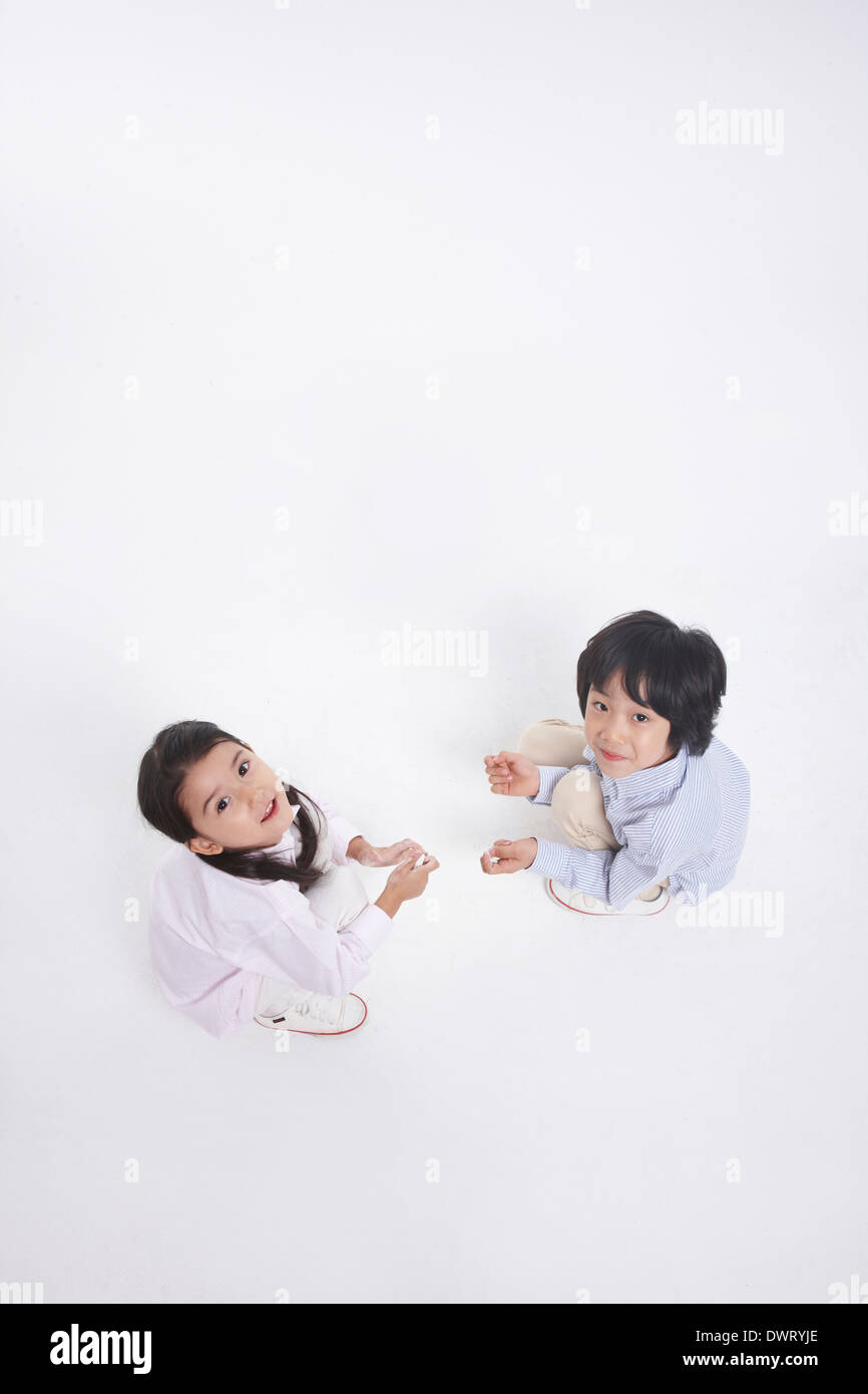 two kids drawing on the floor Stock Photo - Alamy