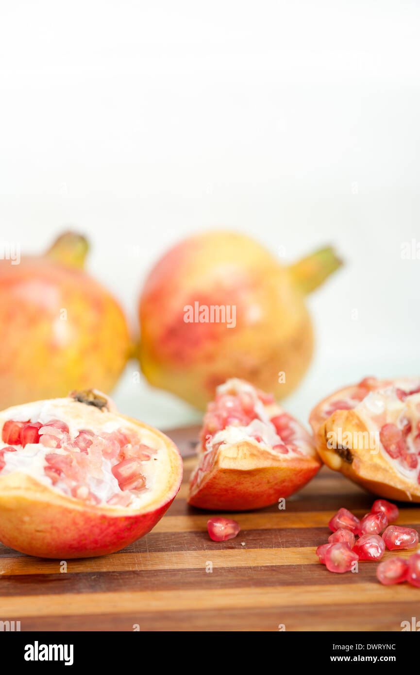 fresh pomegranate fruit on wood over white background Stock Photo