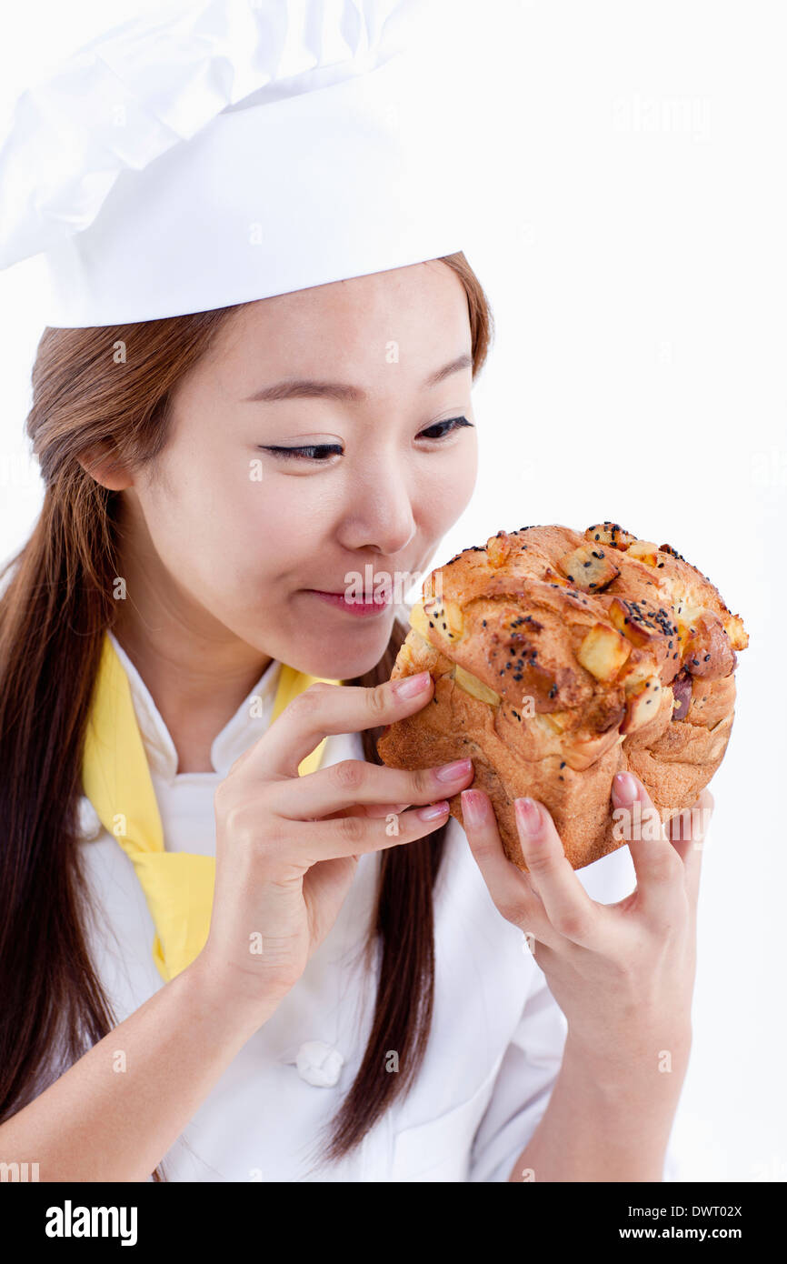 a female pastry chef holding bread Stock Photo Alamy
