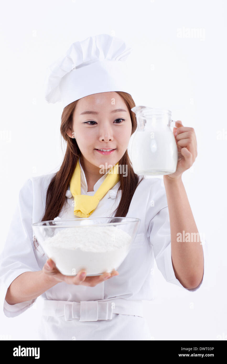 a female pastry chef holding a jar of milk Stock Photo Alamy
