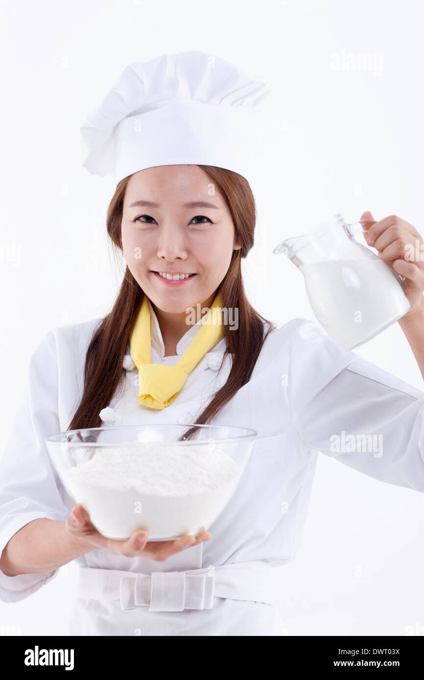 a female pastry chef holding a jar of milk Stock Photo Alamy