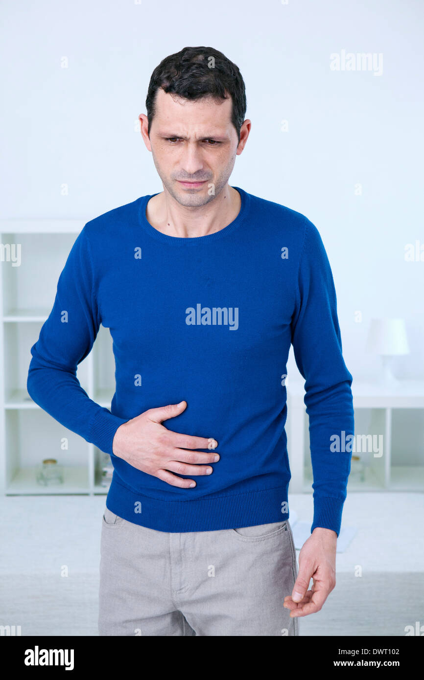 Abdominal pain in a man Stock Photo