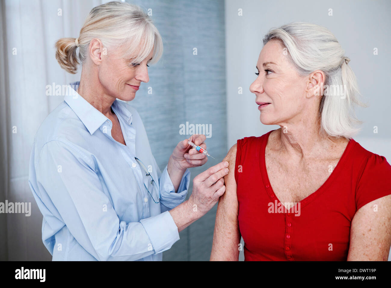 Vaccinating an elderly person Stock Photo