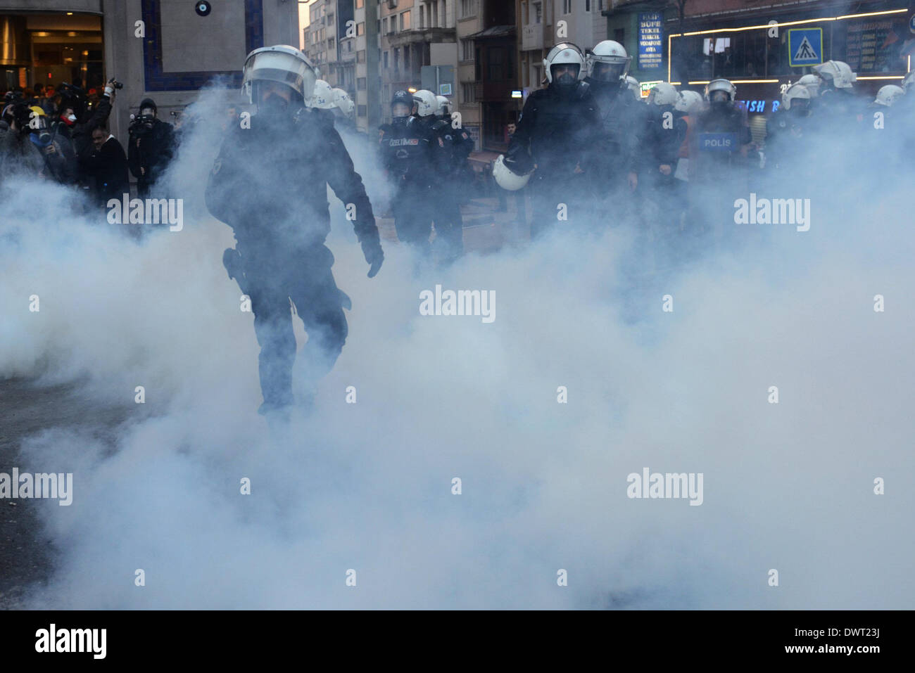 Istanbul, Turkey. 12th Mar, 2014. Riot police disperse protesters with tear gas in Istanbul, Turkey, March 12, 2014. Tension was getting high in Turkey's city of Istanbul on Wednesday as 50,000 people were flocking to a funeral of a 15-year-old student who died Tuesday after 269 days in coma. The death of Berkin Elvan has triggered a nationwide anti-government protests in more than 30 cities in Turkey. Elvan was sent into a coma after sustaining a head injury from a gas canister as he went to buy bread during a police crackdown in Istanbul last June. Credit:  Cihan/Xinhua/Alamy Live News Stock Photo