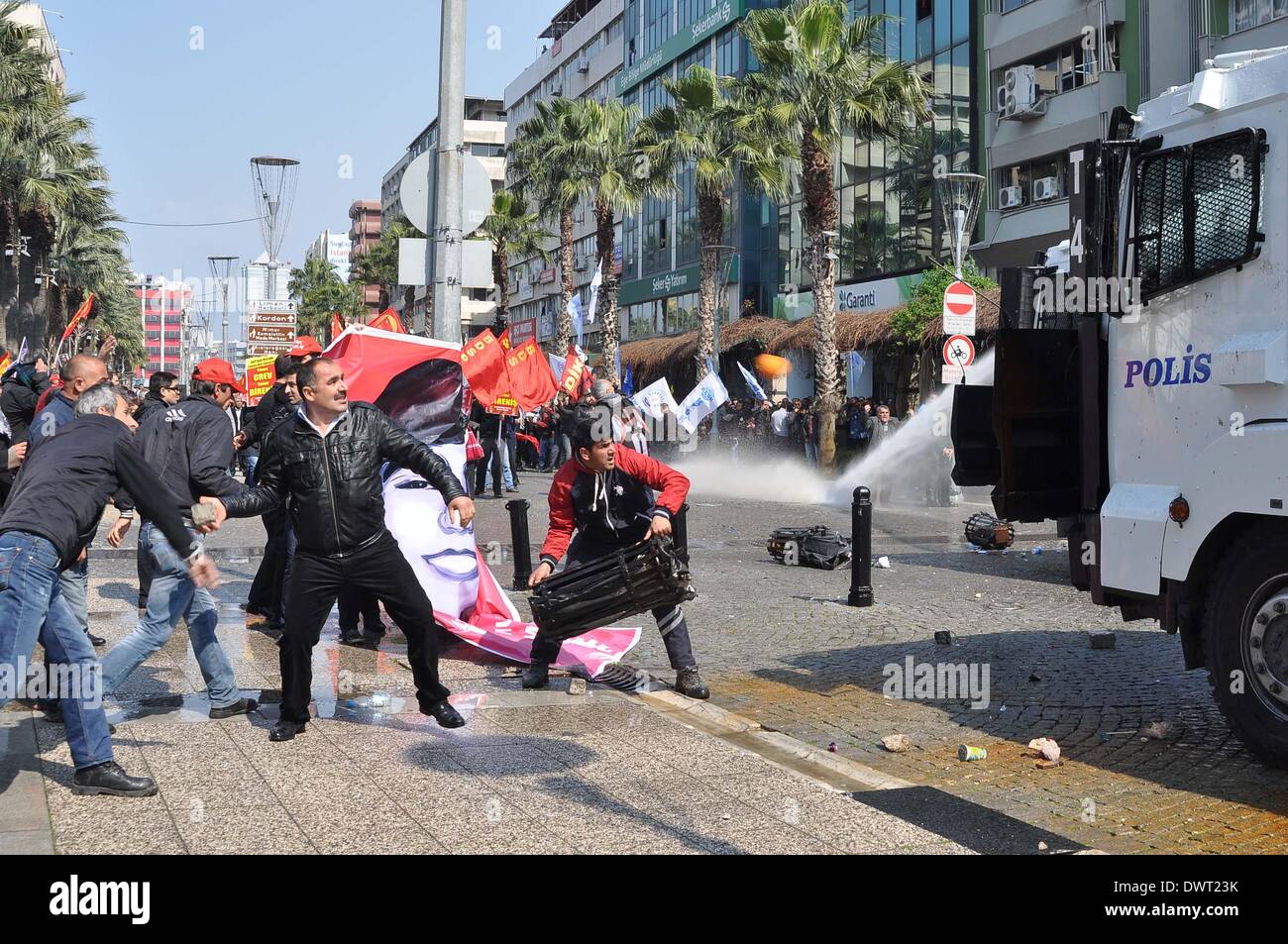 Istanbul, Turkey. 12th Mar, 2014. Riot police dispersed protesters with water cannons in Izmir, Turkey, March 12, 2014. Tension was getting high in Turkey's city of Istanbul on Wednesday as 50,000 people were flocking to a funeral of a 15-year-old student who died Tuesday after 269 days in coma. The death of Berkin Elvan has triggered a nationwide anti-government protests in more than 30 cities in Turkey. Elvan was sent into a coma after sustaining a head injury from a gas canister as he went to buy bread during a police crackdown in Istanbul last June. Credit:  Cihan/Xinhua/Alamy Live News Stock Photo