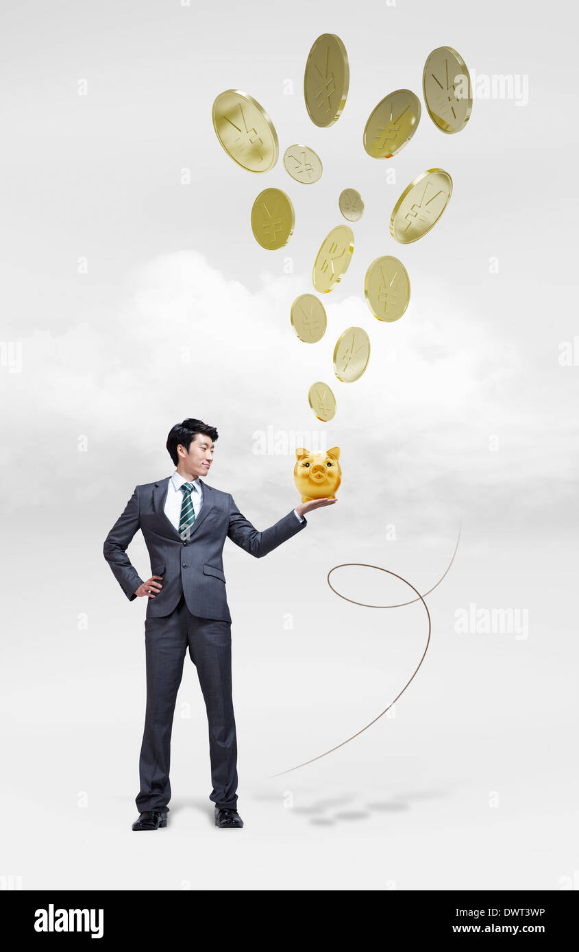 a business man holding a piggy bank Stock Photo - Alamy