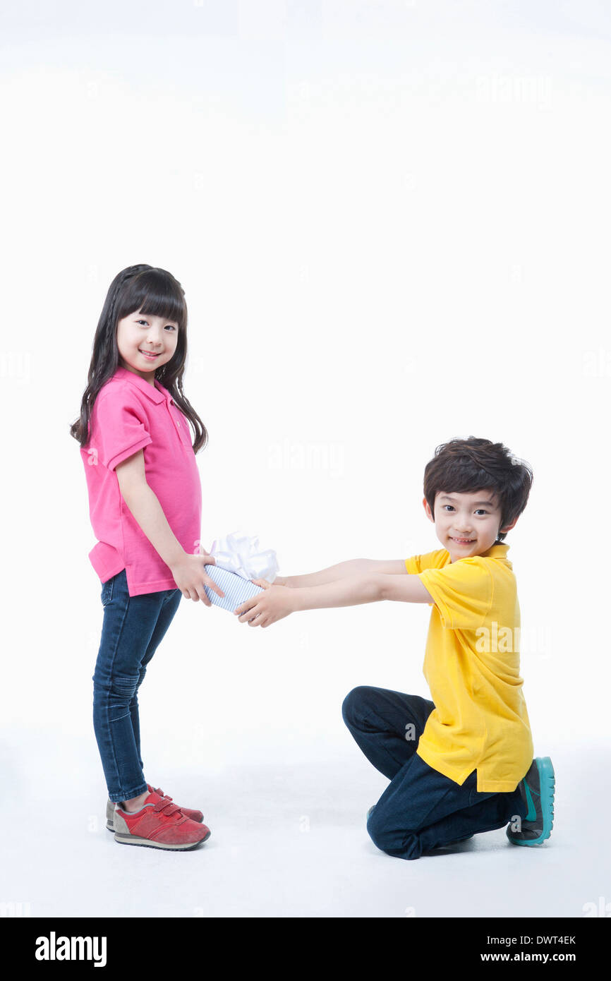 a boy giving girl a present Stock Photo Alamy