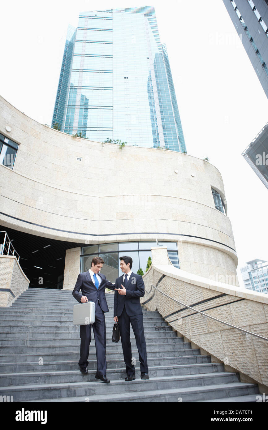 two business men walking the stairs together Stock Photo