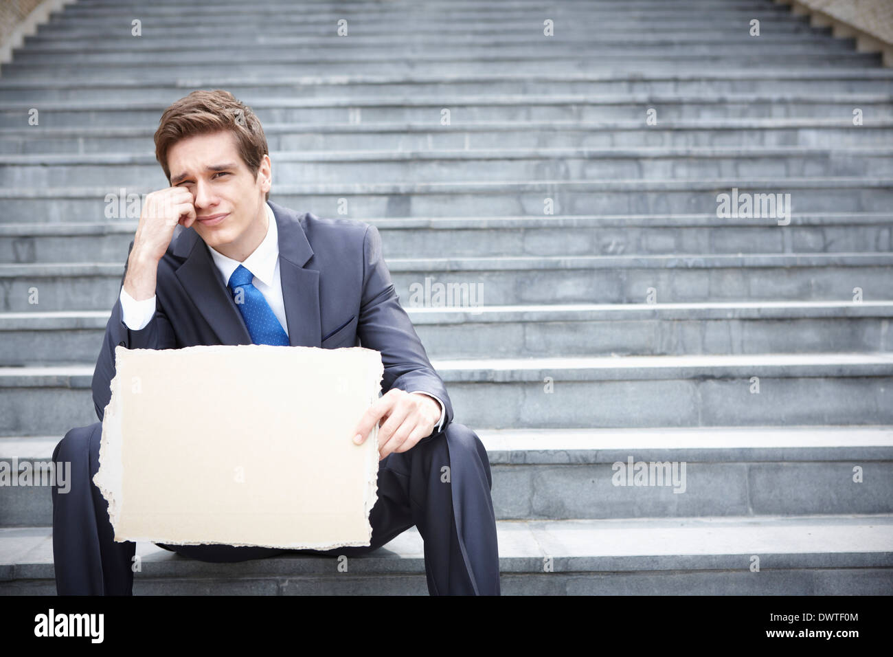 a business man sitting on the stairs with a copy space Stock Photo