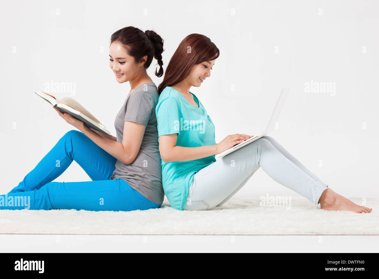 two women sitting on the floor Stock Photo - Alamy