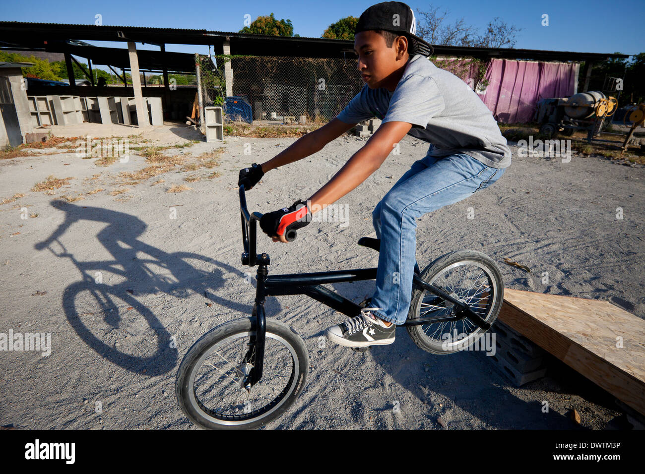 Young Panamanian boy playing with his bicycle in Penonome, Cocle province, Republic of Panama. Stock Photo