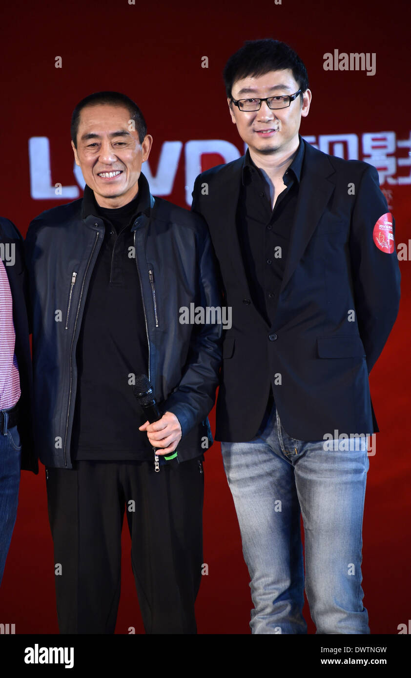 Beijing, China. 13th Mar, 2014. Director Zhang Yimou (L) poses for a photo with honored guest Lu Chuan during the press conference of his new movie 'Return' in Beijing, capital of China, March 13, 2014. The movie in which starred by Gong Li and Chen Daoming will be screened in May. Credit:  Xinhua/Alamy Live News Stock Photo