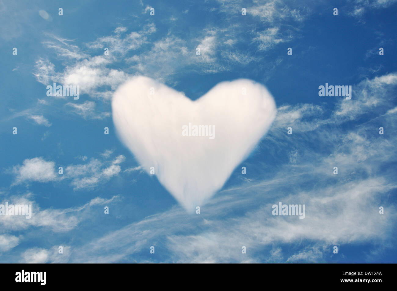 Cloud forming heart shape in blue sky, digital composite Stock Photo