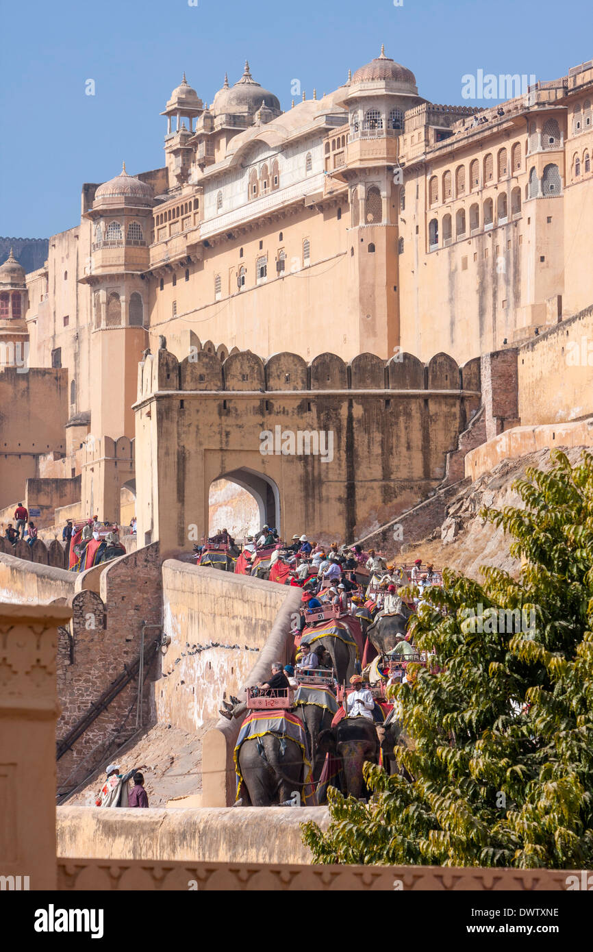 Amber (or Amer) Palace, near Jaipur, India. Tourists Riding Elephants to the Sun Gate (Suraj Pole), Entrance to Main Courtyard. Stock Photo