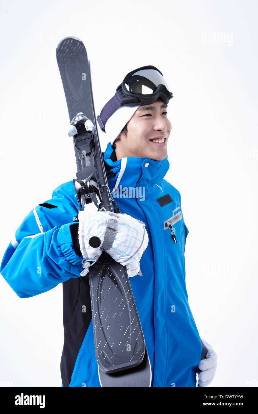 a man holding a pair of skis Stock Photo