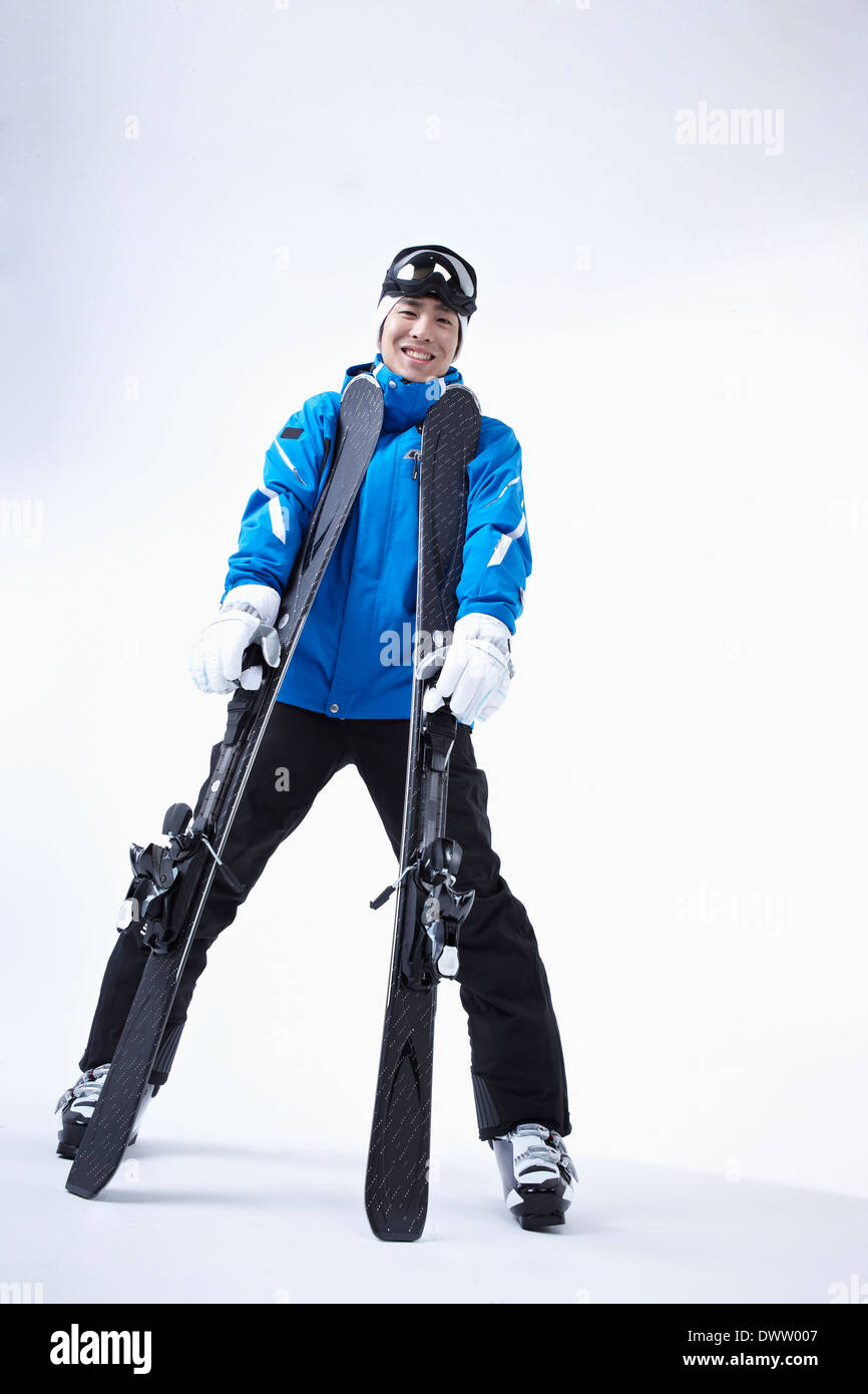 Man holding pair skis hi-res stock photography and images - Alamy