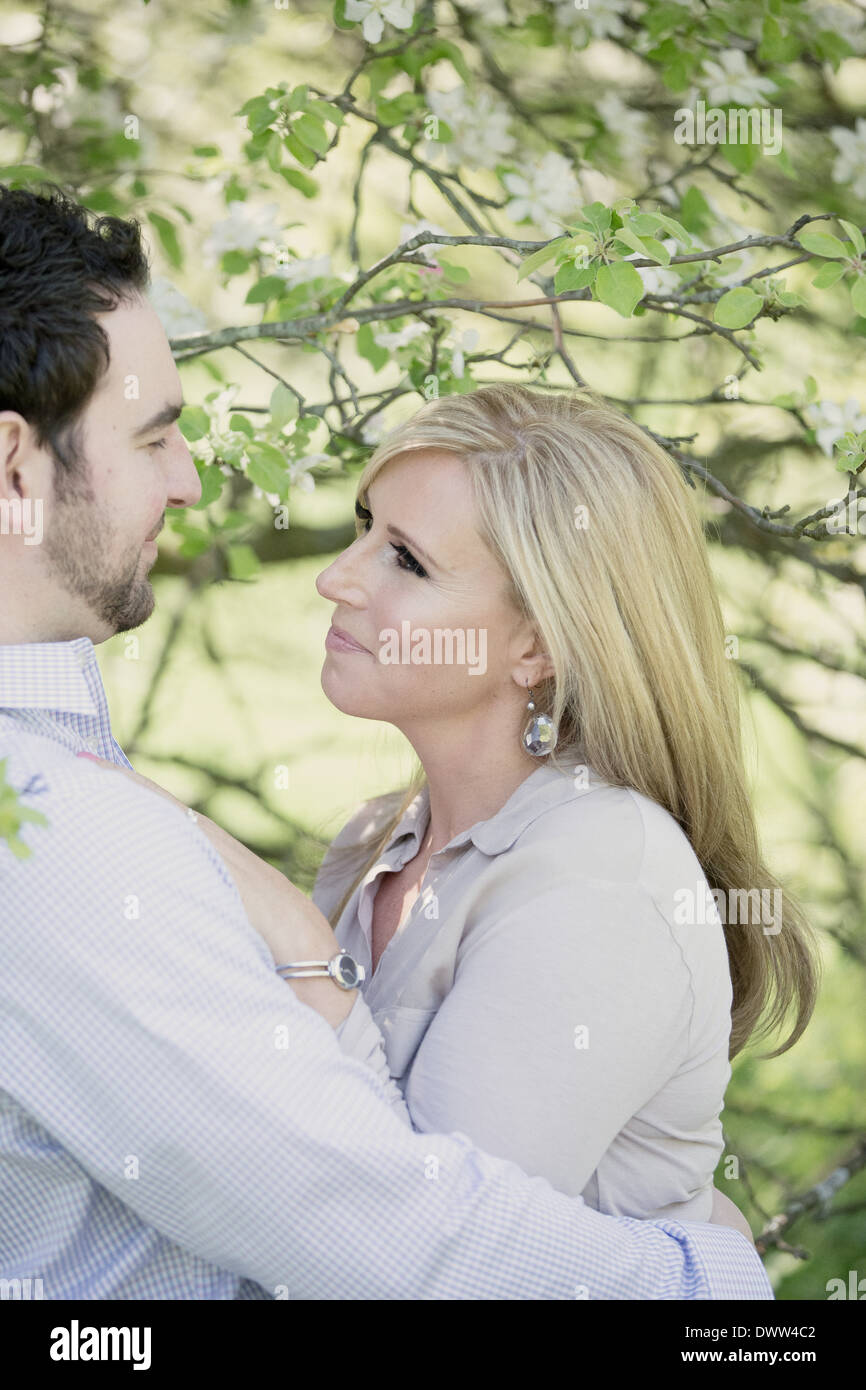 man and woman together in orchard Stock Photo