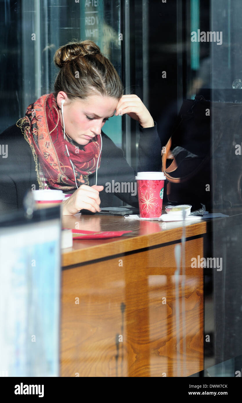 people coffee shop solitary moment woman looking at electronic device Illinois Chicago's Michigan Avenue. Chicago, Illinois, USA. Stock Photo