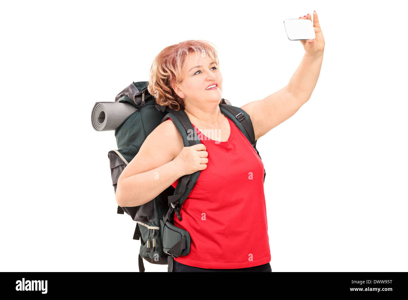 Woman with hiking equipment taking a selfie Stock Photo