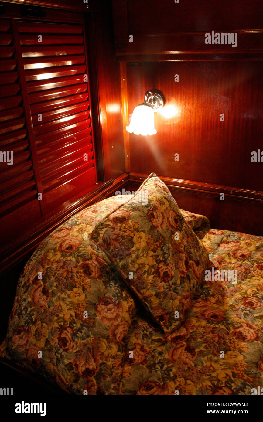 The luxury suite in the cabin of the luxury Rovos Rail train has two single beds placed in an L-shape. Stock Photo