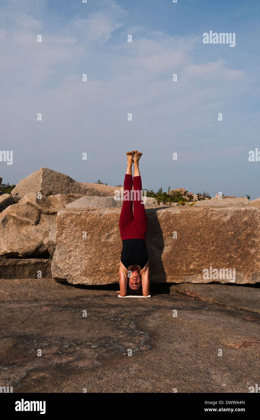Iyengar Yoga Instructor Demonstrates Pincha Mayurasana (Inverted Stock