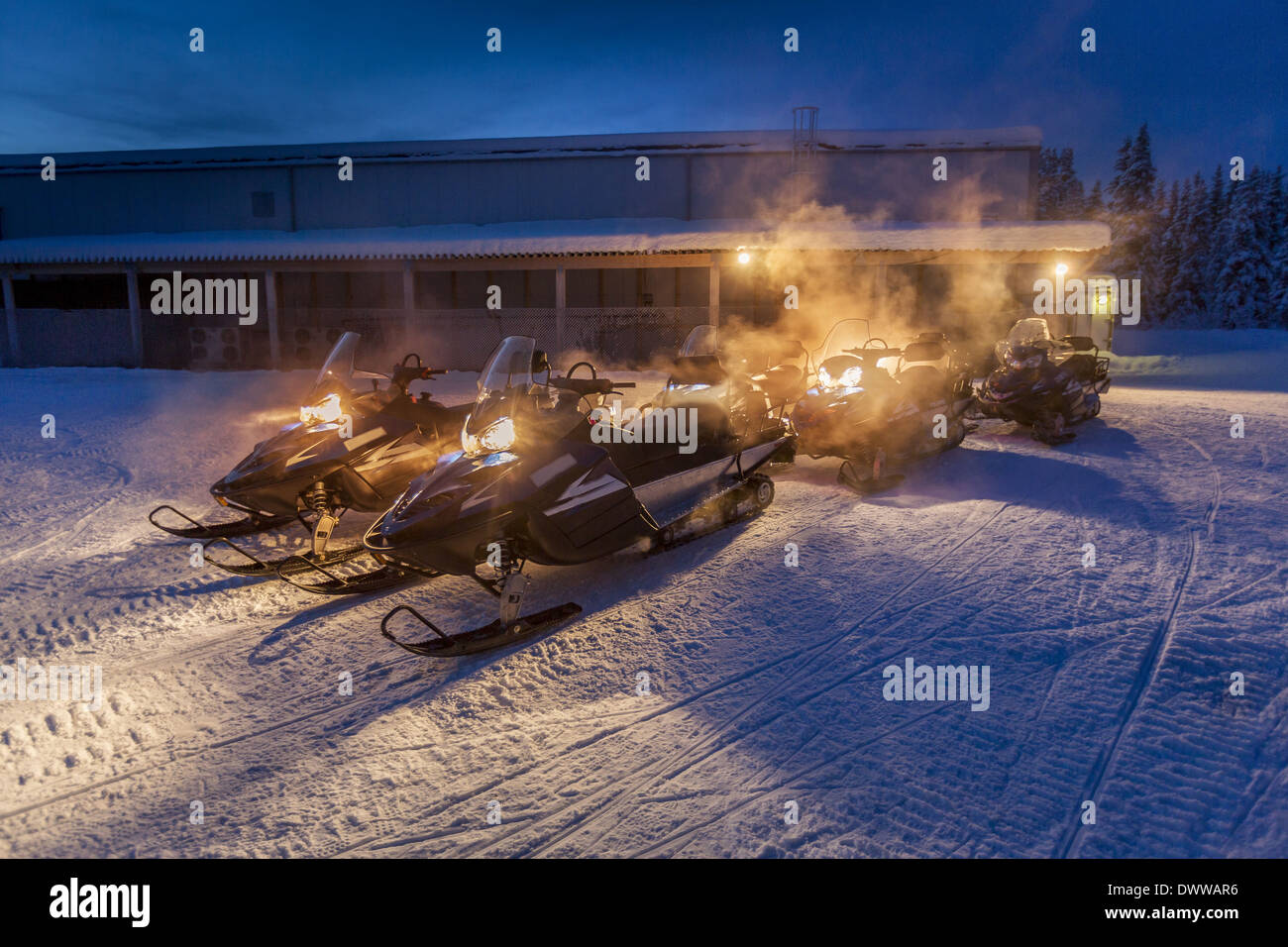 Snowmobiles in the freezing cold temperatures as low as -47 celsius. Lapland, Sweden Stock Photo