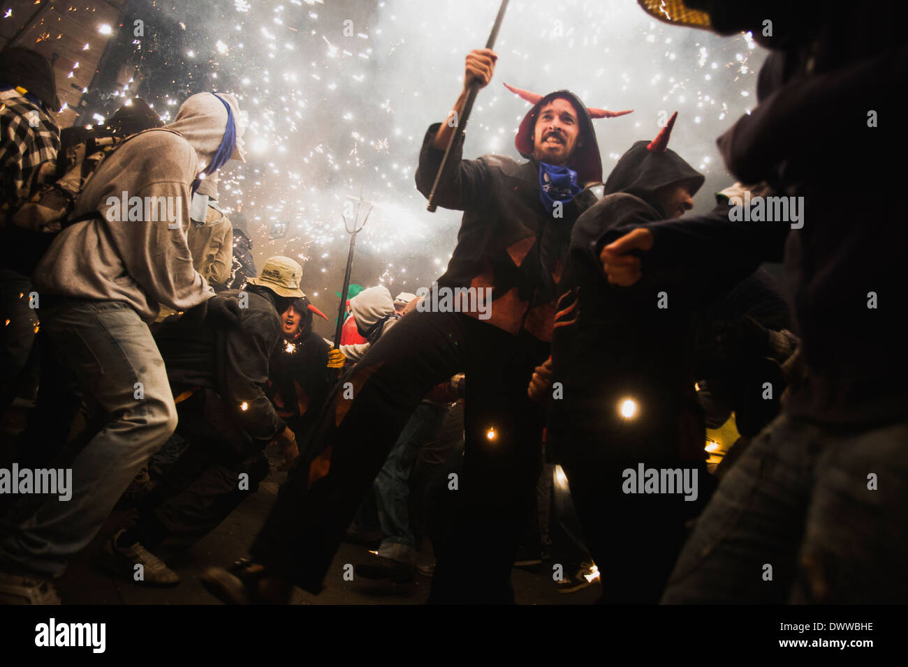 People dancing under the fireworks of a correfoc, a Catalan tradition ...