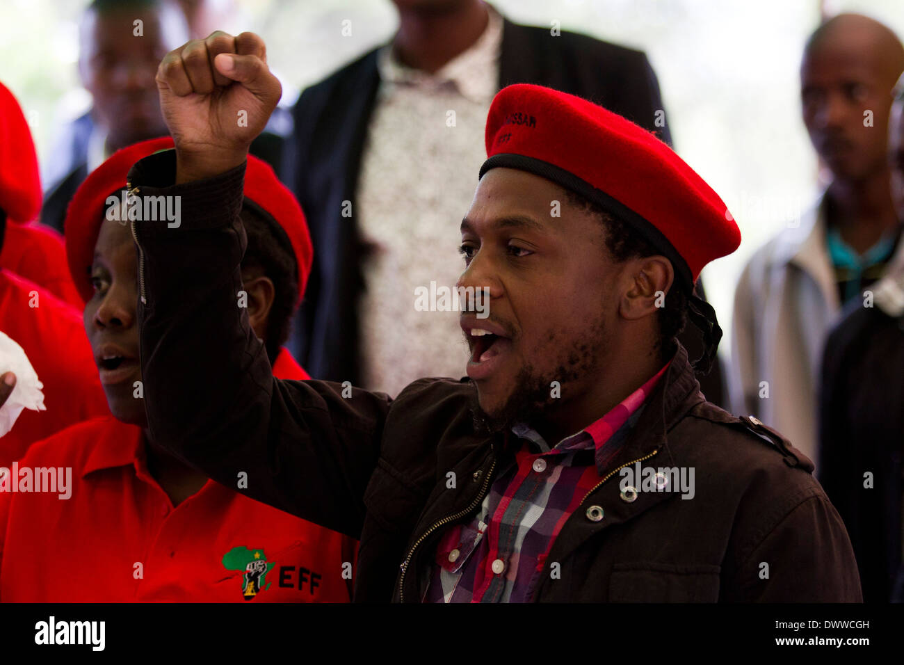 Economic Freedom spokesman Mbuyiseni Ndlozi punches the air with supporters before handing over a house which they built to a Stock Photo