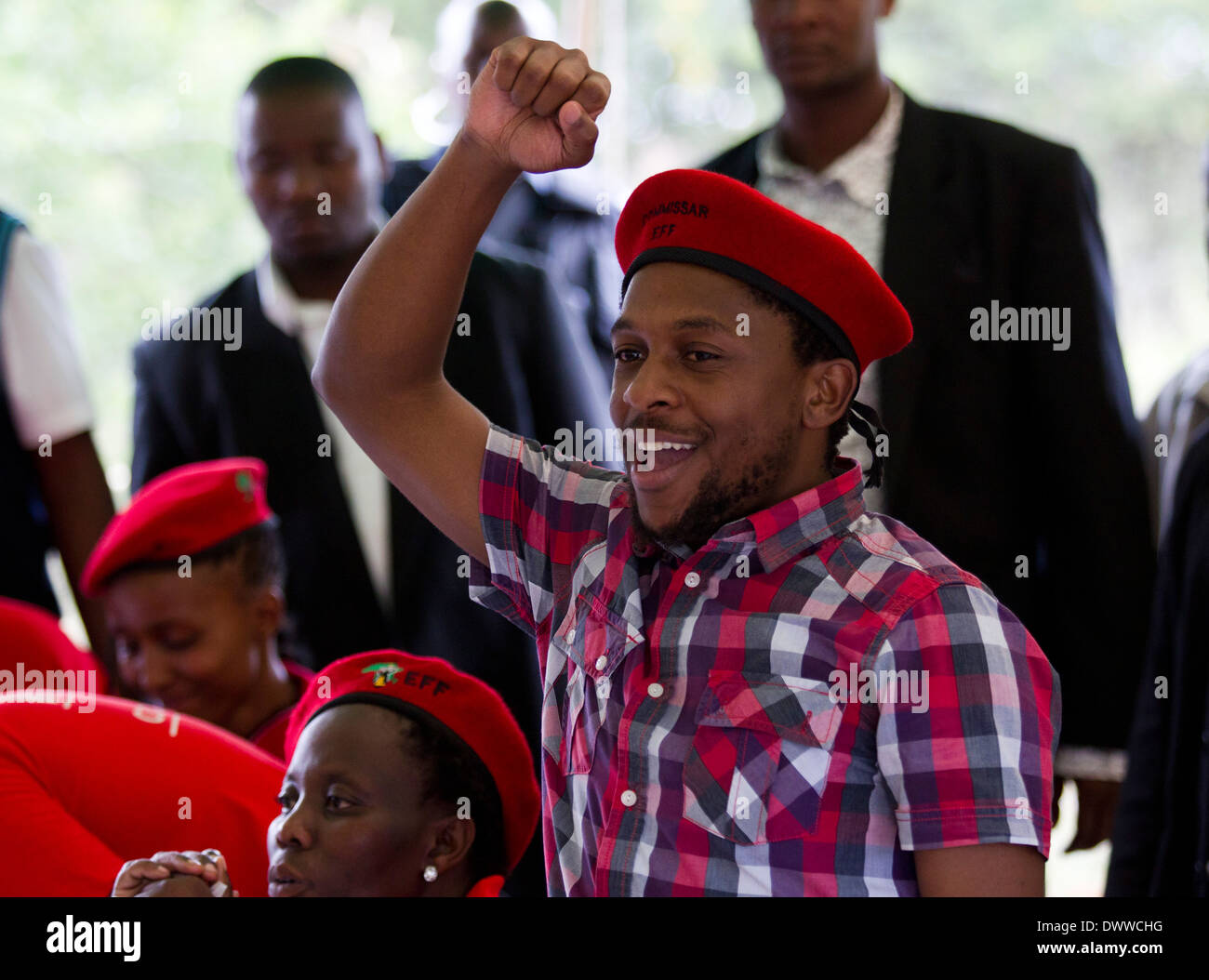 Economic Freedom spokesman Mbuyiseni Ndlozi punches the air with supporters before handing over a house which they built to a Stock Photo