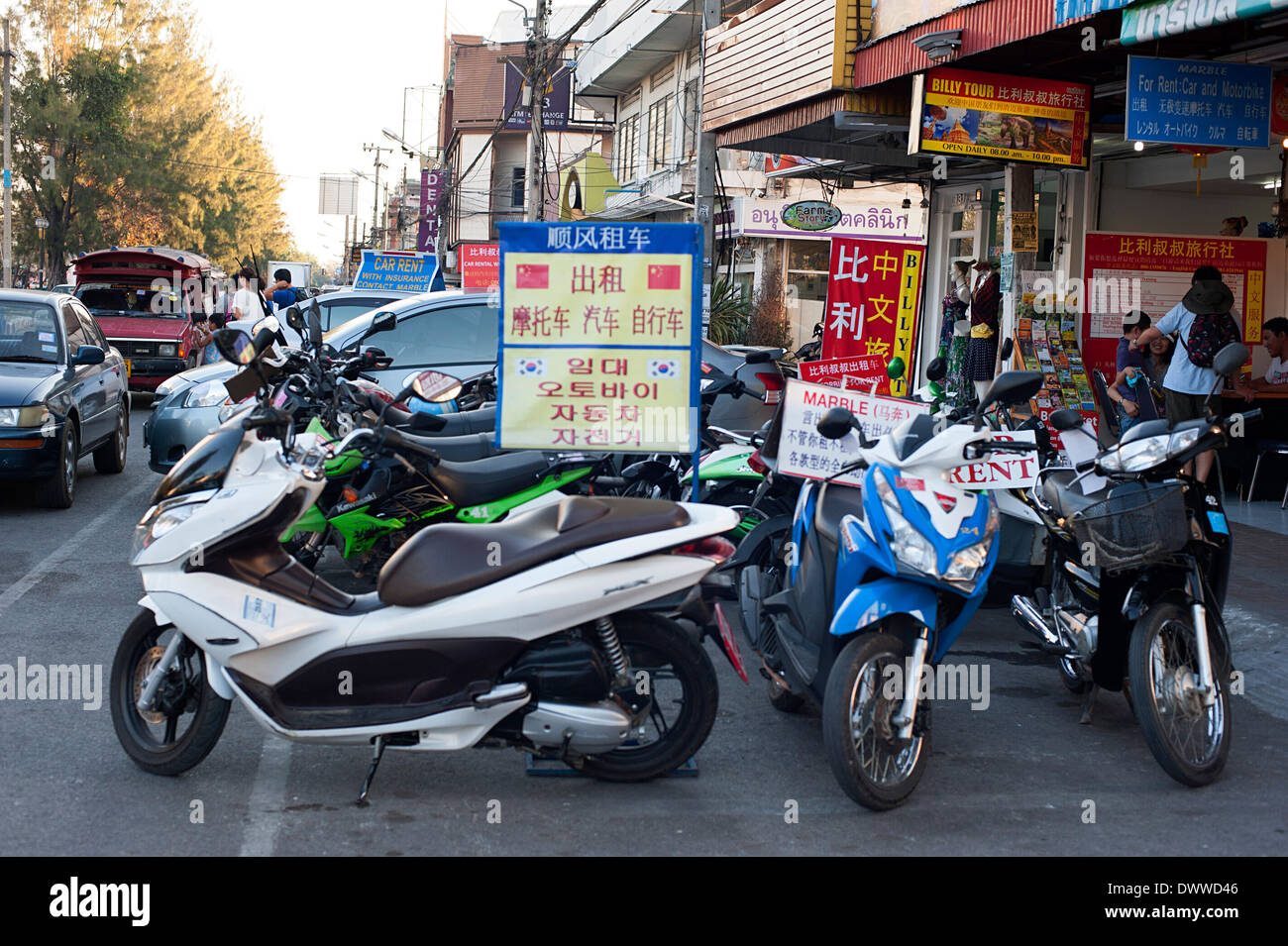 Motorbikes to rent  displayed outside shop on road along Ping canal. Stock Photo