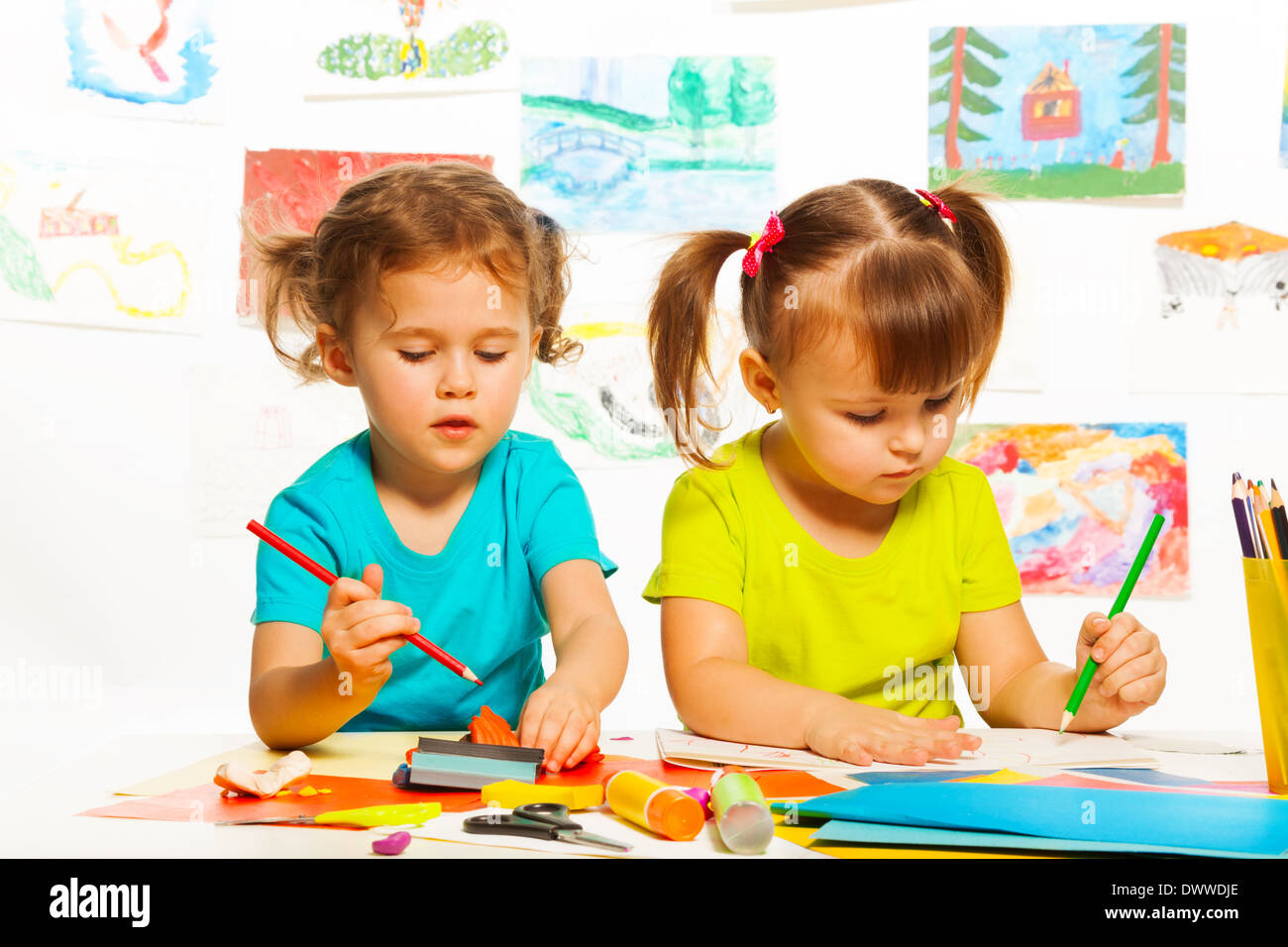 Two little girls painting on creative class in kindergarten Stock Photo ...