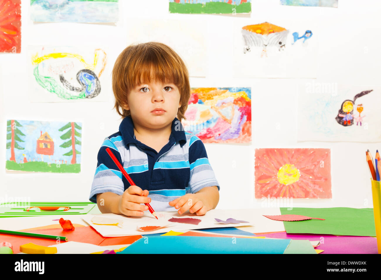 Cute little 2 years old boy in the art class draw with pencil Stock