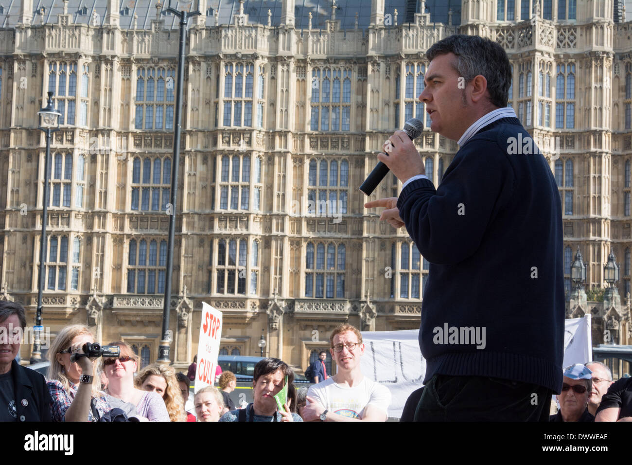 Dominic Dyer of the Badger Trust speaks as protesters gather outside Westminster while a parliamentary debate on the controversial badger cull takes place inside the house of commons. Badgers have been linked to the spread of bovine tuberculosis in cattle and experimental culls of badgers were carried out in 2013 in an attempt to stop the spread of the disease. Anti-cull protestors have claimed that the cull is inefficient, inhumane and scientifically flawed. Stock Photo