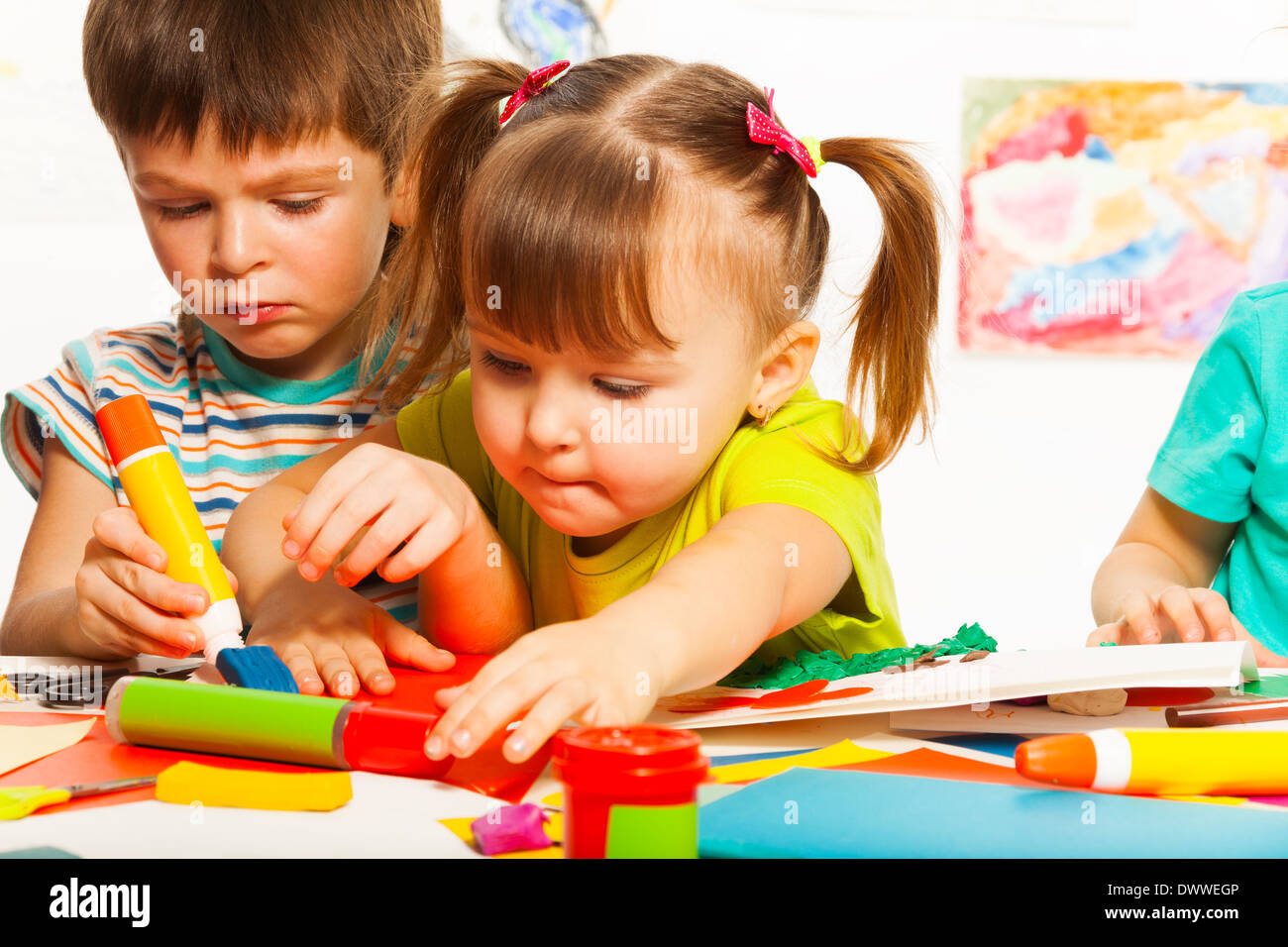 Two little kids crafting with painting and bluing tools on creative school class Stock Photo