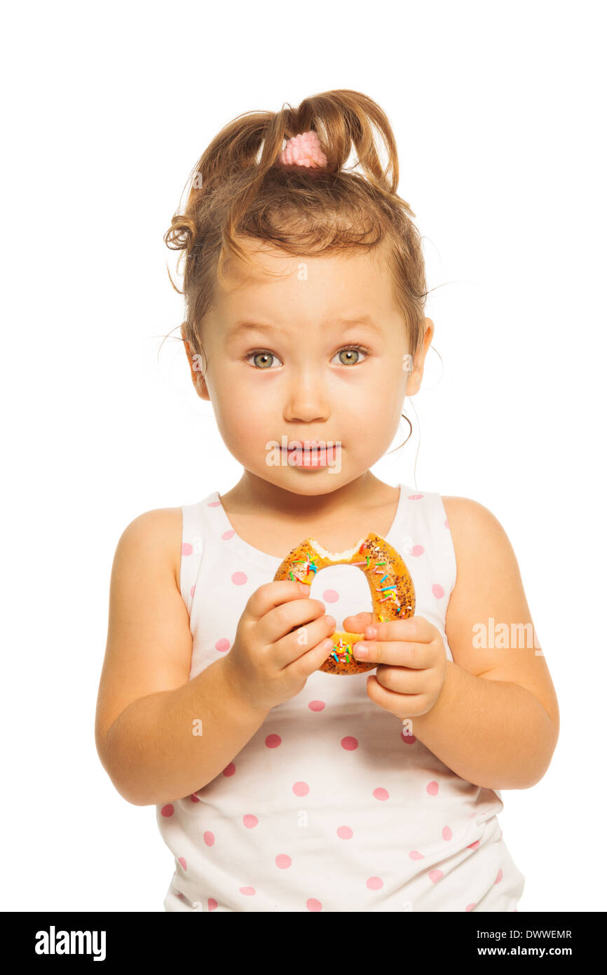 Close portrait of Asian girl with ponytails with donut  Stock Photo