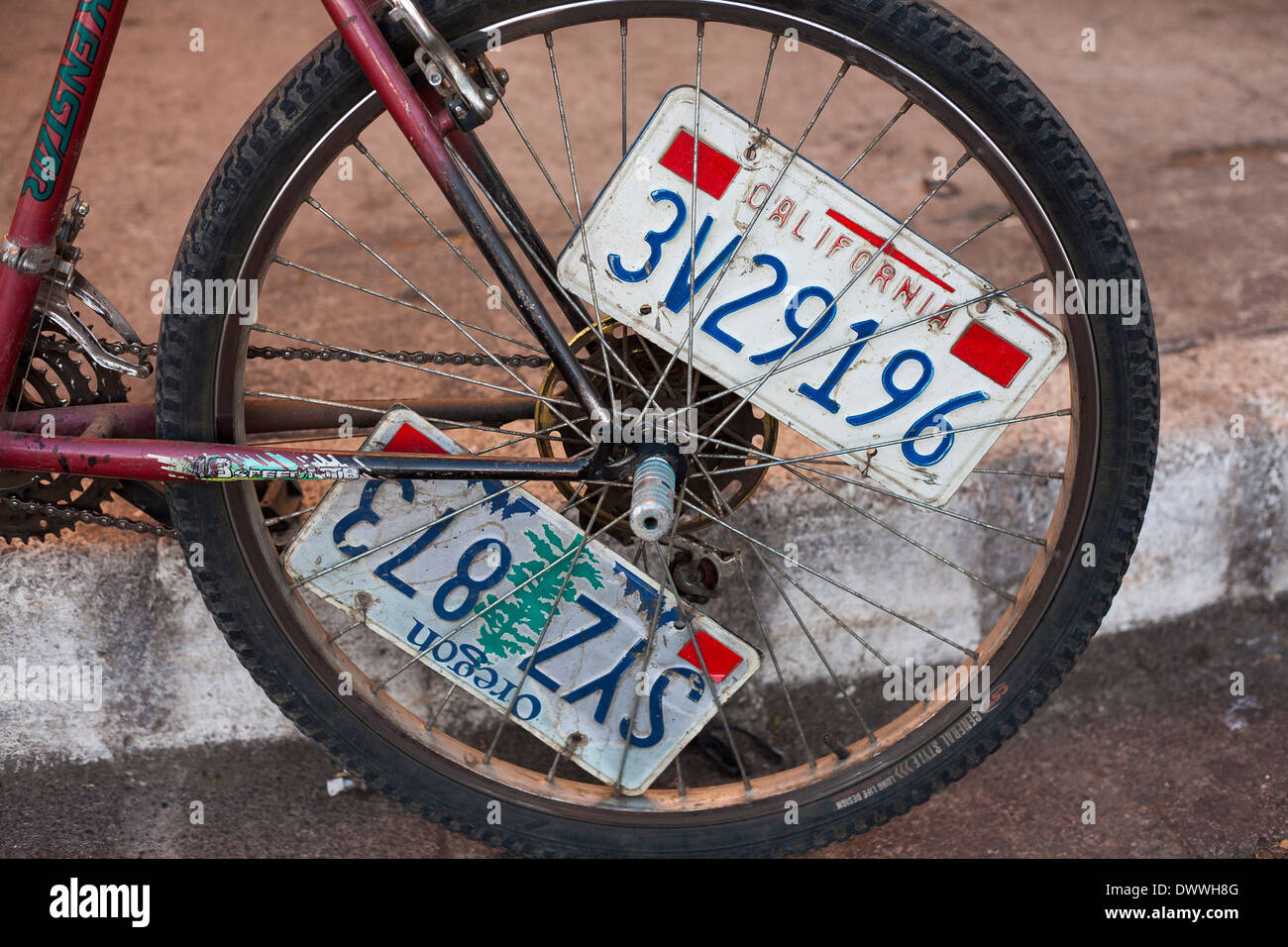 American car license plates decorate a bicycle wheel, souvenirs from the USA in Juayua on the rutas de la flores in El Salvador Stock Photo