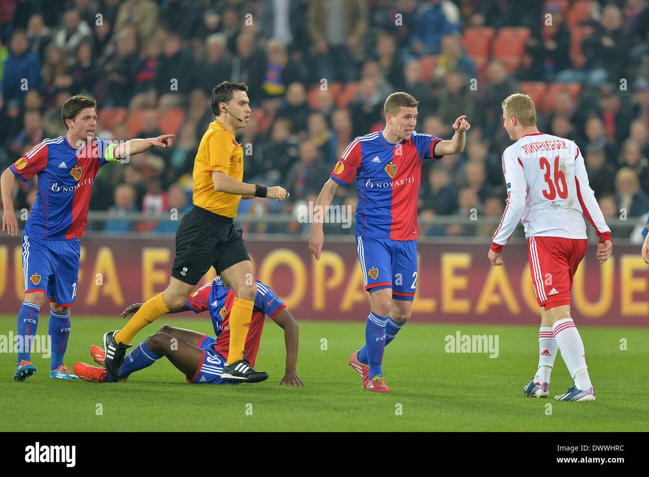 Basel, Switzerland. 13th Mar, 2014. Europa League football. FC Basel versus  Red Bull Salzburg. Basel's Valentin Stocker and Fabian Frei challenge Martin  Hinteregger about the foul as the ref steps in Credit: