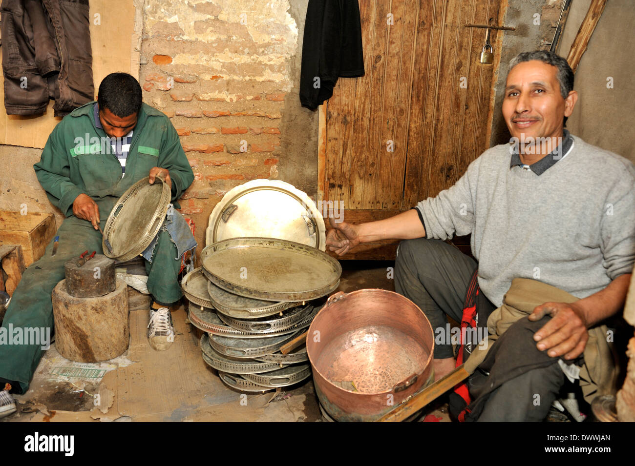 Metal smith in small workshop off one of the souks near Place Jemaa El Fna Marrakech, Morocco, North Africa Stock Photo
