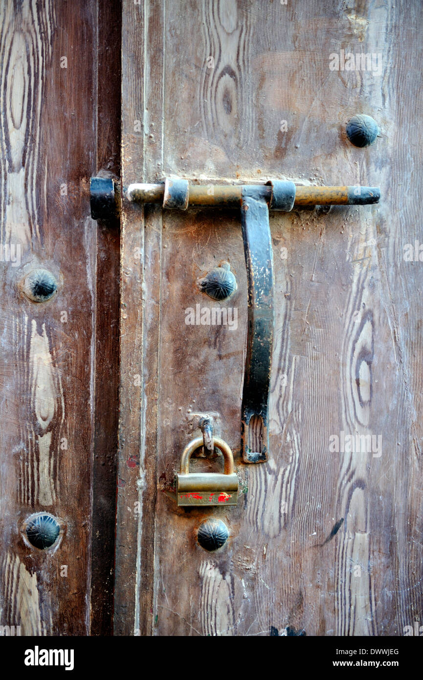 Old wooden door with sliding bolt hasp and lock, unlocked, Marrakech, Morocco Stock Photo