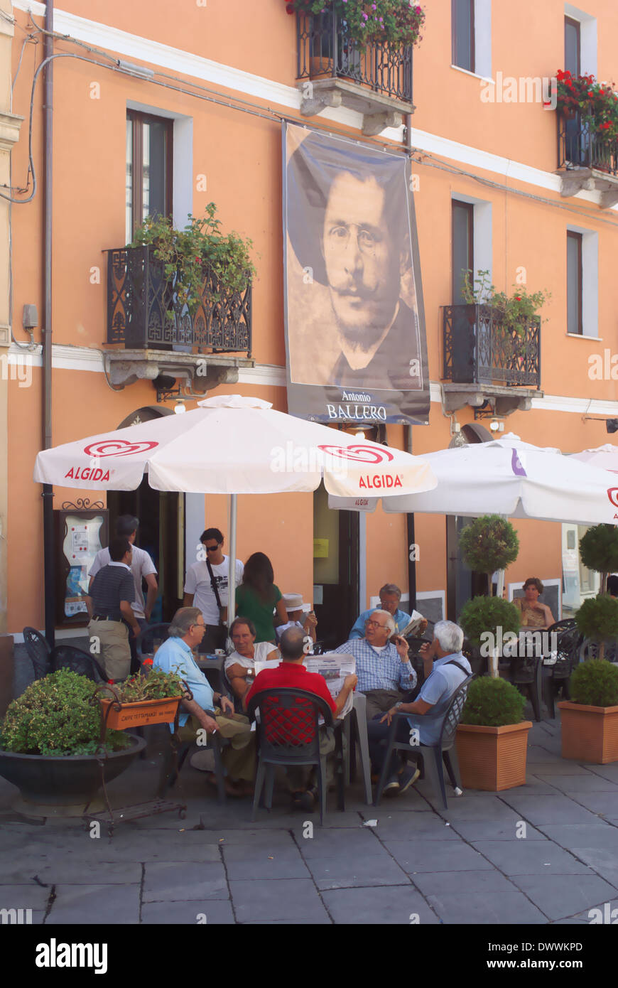 people sitting outside cafe in Sardinia. Stock Photo